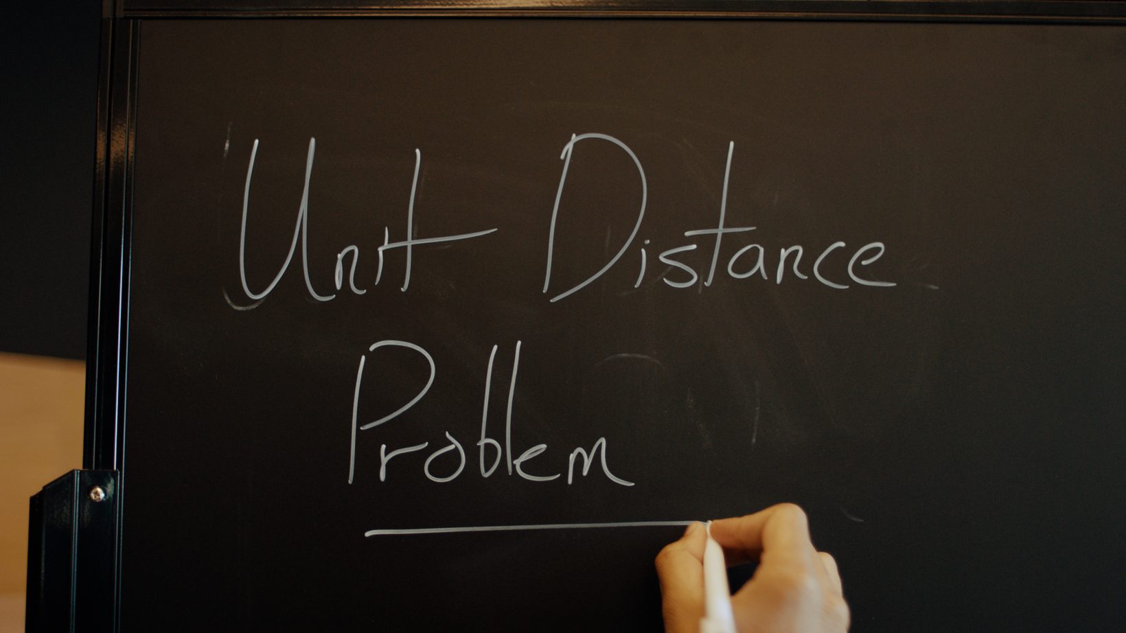 Unit Distance Problem — 칠판에 손으로 쓴 "Unit Distance Problem" 글자, 발표 영상의 오프닝 컷