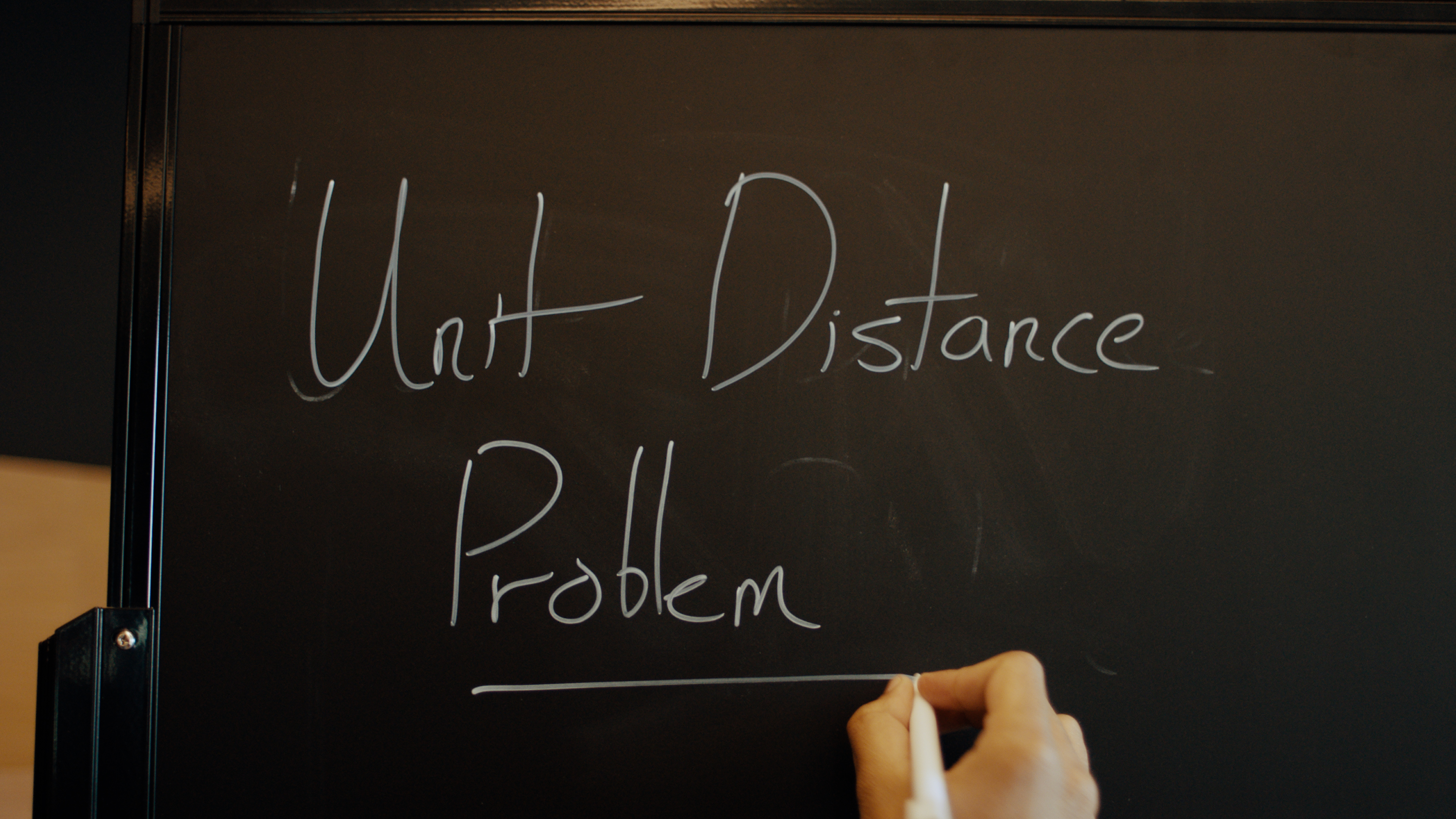 Unit Distance Problem — 칠판에 손으로 쓴 "Unit Distance Problem" 글자, 발표 영상의 오프닝 컷